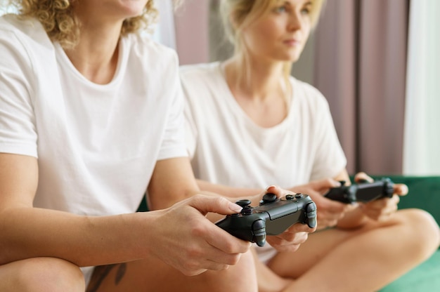 Two young girls playing video game console in living room