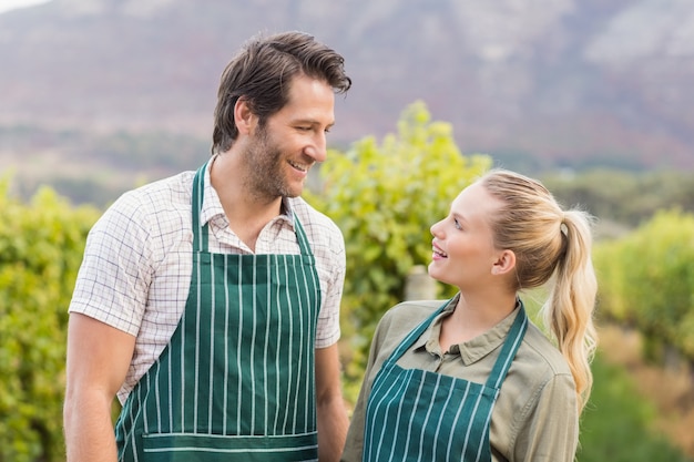 Two young happy vintners looking at each other