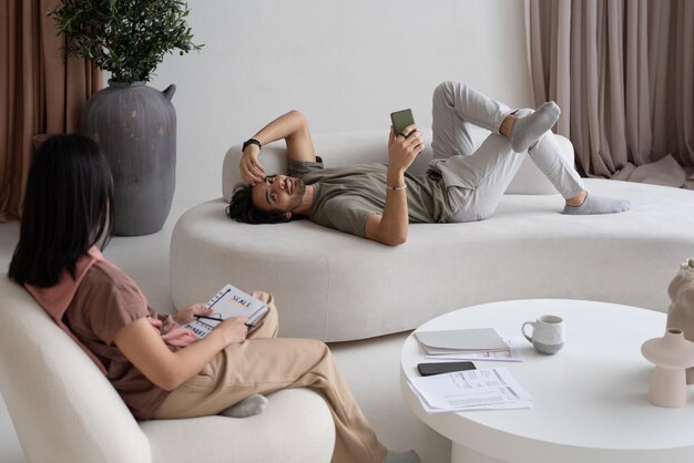 Photo two young interracial employees in casualwear working from home