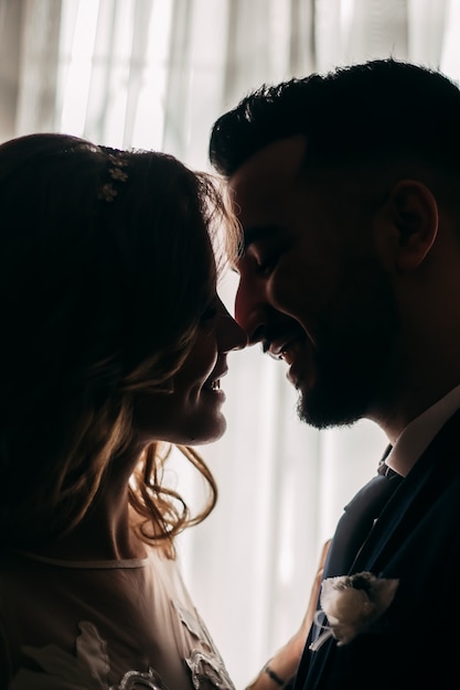 Two young lovers. Profiles of romantic couple looking at each other