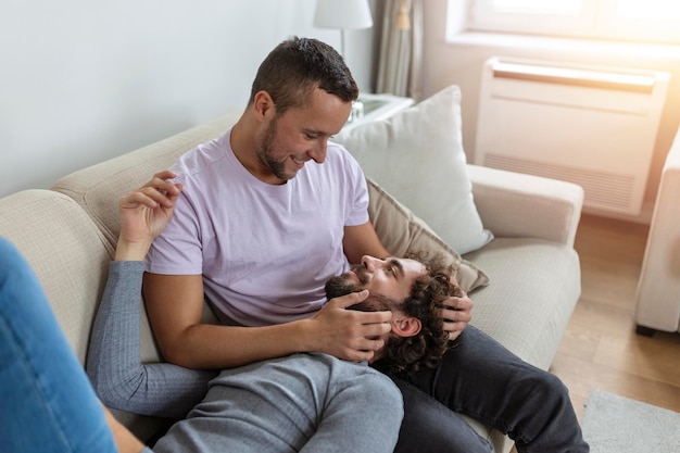 Two young man lgbtq gay couple dating in love hugging enjoying intimate tender sensual moment together kissing with eyes closed