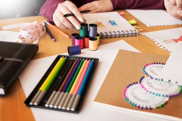 two young men working as fashion designers and drawing sketches