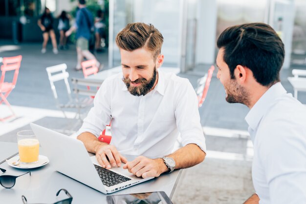 two Young modern businessman posing