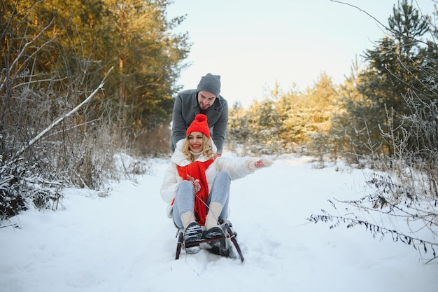 Two young people sliding on a sled