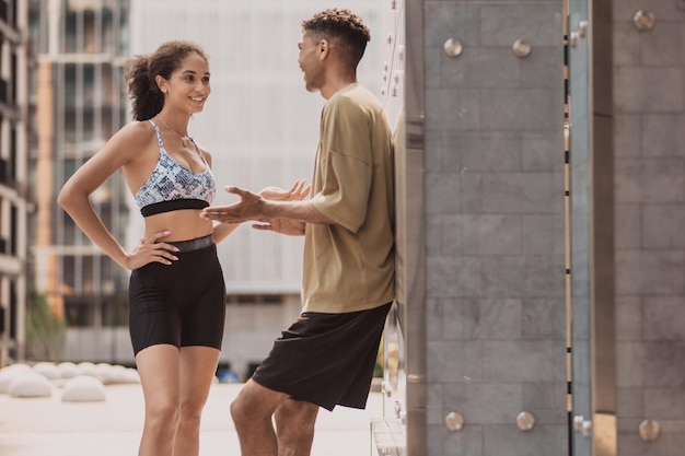 Two young people talking and discussing abs exercises