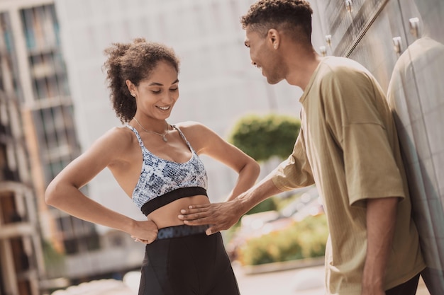 Two young people talking and discussing abs exercises