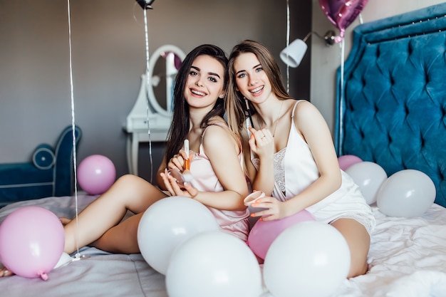 Two young pretty models preparing before hen party