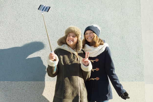 Two young teenage girls having fun outdoors