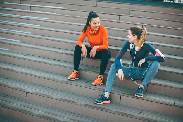 Two young woman resting after running