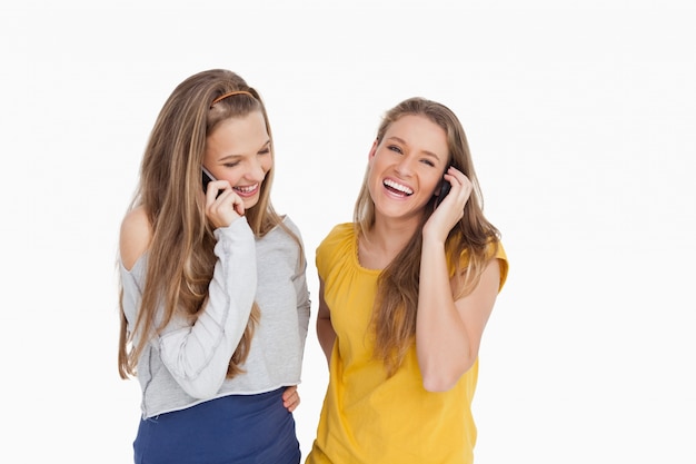 Two young women laughing on the phone