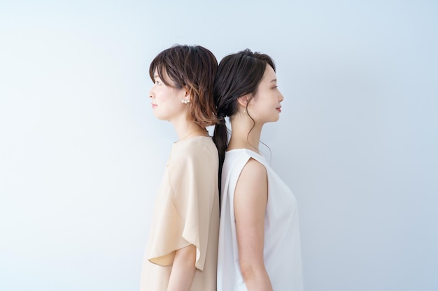 Two young women lined up with a smile