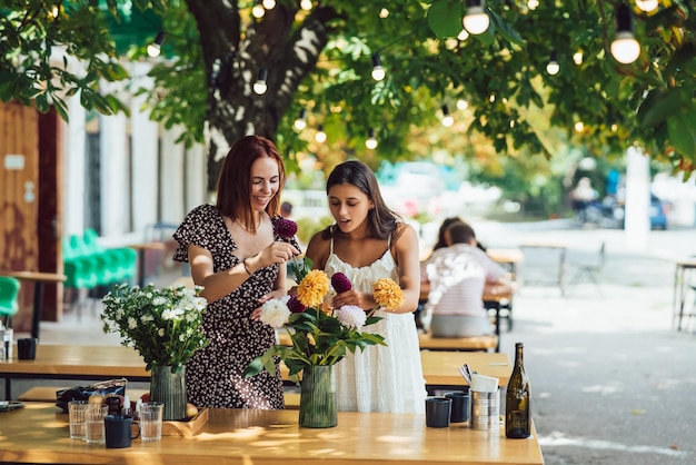 Two young women make up a beautiful festive bouquet