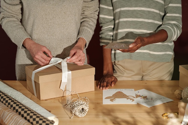 Two young women preparing presents