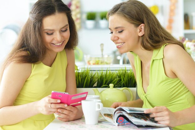 Two young women talking in the kitchen