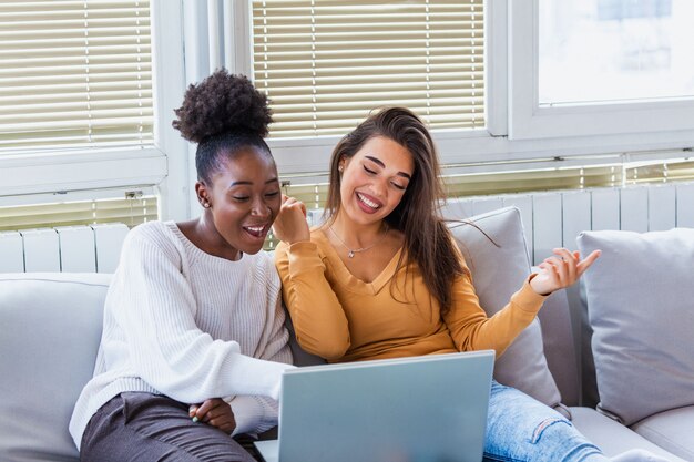 Two young women watching a movie at home