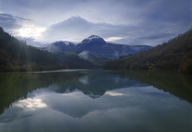 Txindoki with snow Mount Txindoki reflected in the Ibiur reservoir Basque Country