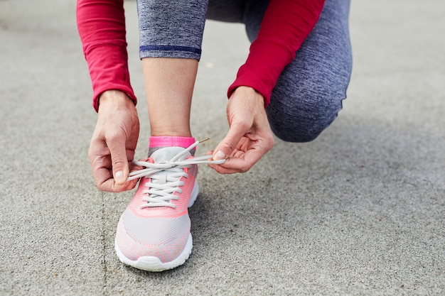 Tying Pink Sports Shoe