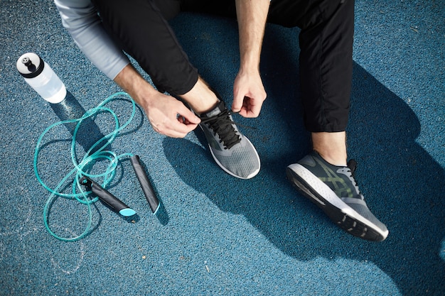 Tying sport shoes outdoors