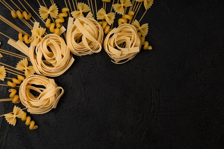 Types of pasta on a black background