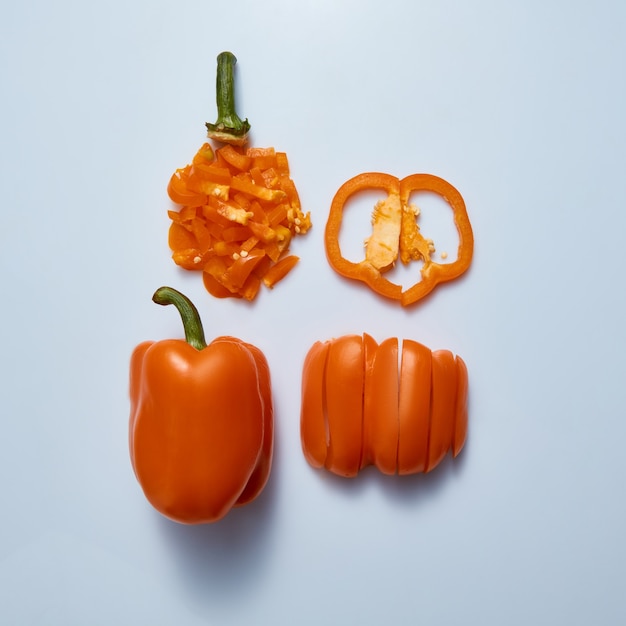 Types of slicing sweet yellow pepper for cooking. Four different peppers are isolated