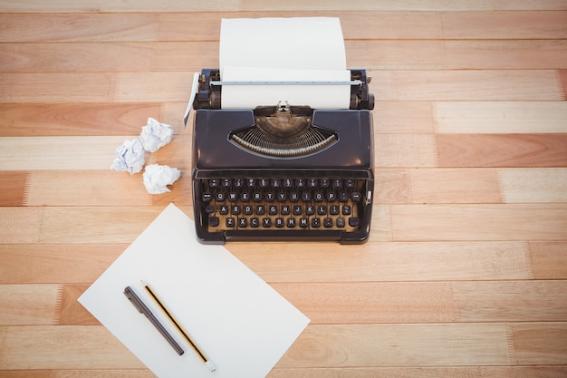 Typewriter and paper on table in office