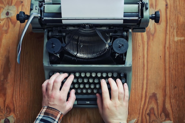 Typewriter retro hand on wooden table