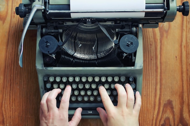 Typewriter retro hand on wooden table