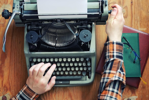 Typewriter retro hand on wooden table