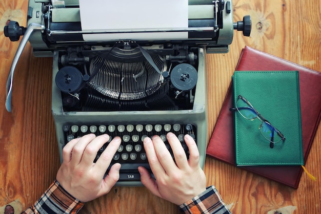 Typewriter retro hand on wooden table