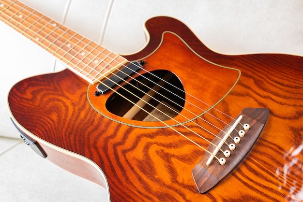 Typical acoustic guitar on white background Selective focus