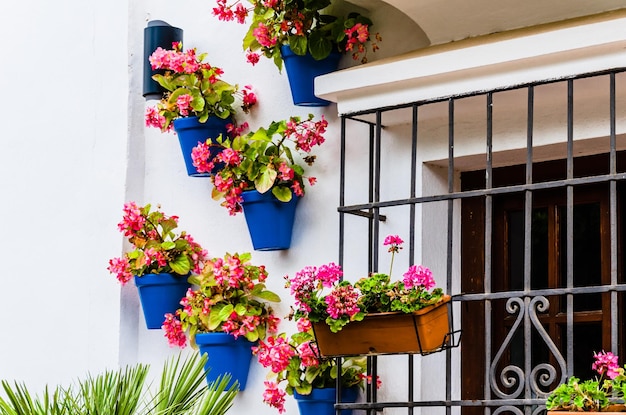 Typical Andalusian white facade with hanging blue pots Andalusian village Marbella