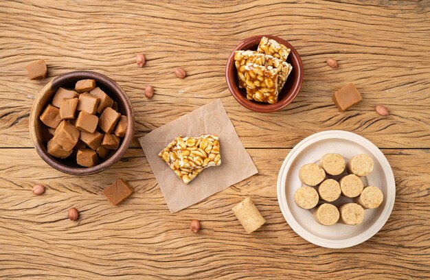 Typical brazilian candies over wooden table Doce de leite or dulce de leche pe de moleque and pacoca