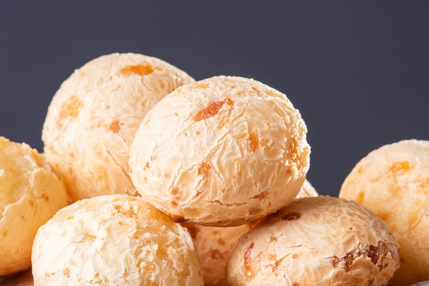 Typical Brazilian cheese bread. Close-up photo of some cheese bread. Grey background.