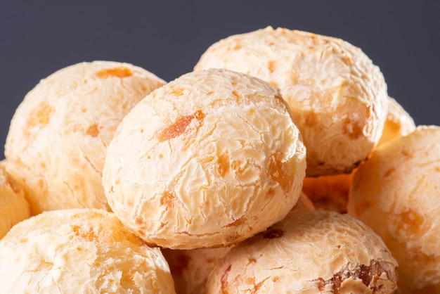 Typical Brazilian cheese bread. Close-up photo of some cheese bread. Grey background.