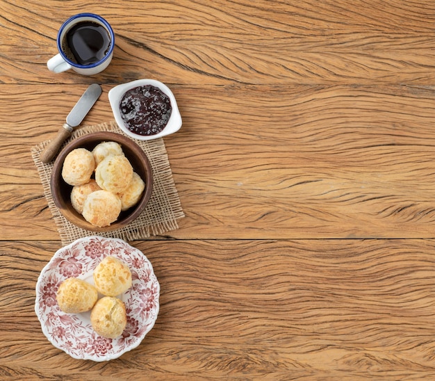 Typical brazilian cheese bun on a plate coffee jam and copy space