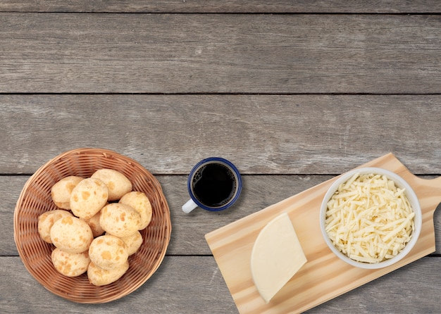 Typical brazilian cheese buns in a basket with coffee, cheese and copy space.