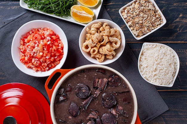 Typical Brazilian dish called Feijoada. Made with black beans, pork and sausage. Top view