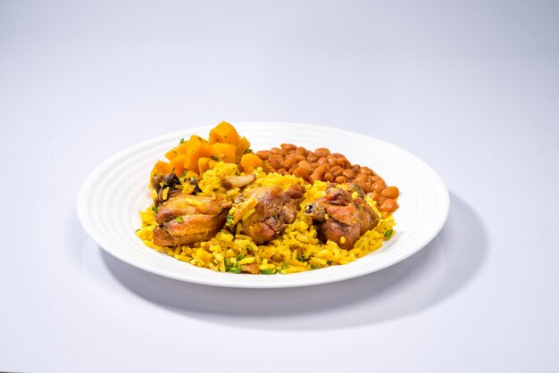 typical brazilian dish galinhada with curcuma seasoned chicken and rice on rustic set