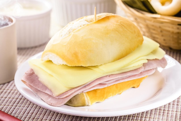 Typical Brazilian snack pao de sal with sliced mozzarella cheese and ham french bread for breakfast