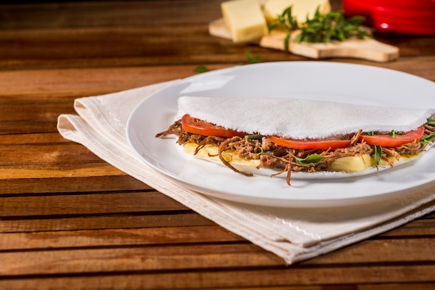 Typical brazilian tapioca food with sun meat  carne de sol  cheese and tomato filling