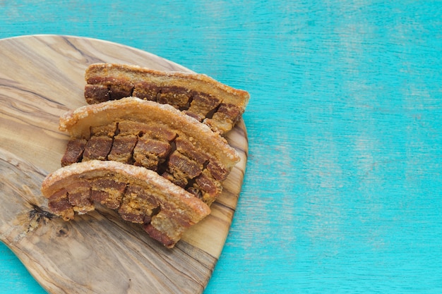 Typical Colombian food. Colombian fried pork rinds on a blue background