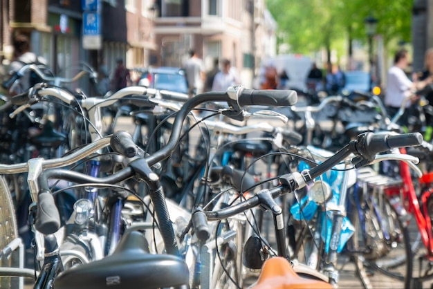전형적인 네덜란드 교통 풍경은 화창한 날 네덜란드 유럽의 한 도심에 있는 자전거 주차장에 연속으로 주차된 자전거가 많이 있습니다.