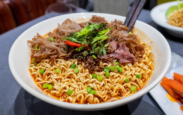 Typical Indonesian chicken noodles served in a bowl with delicious toppings