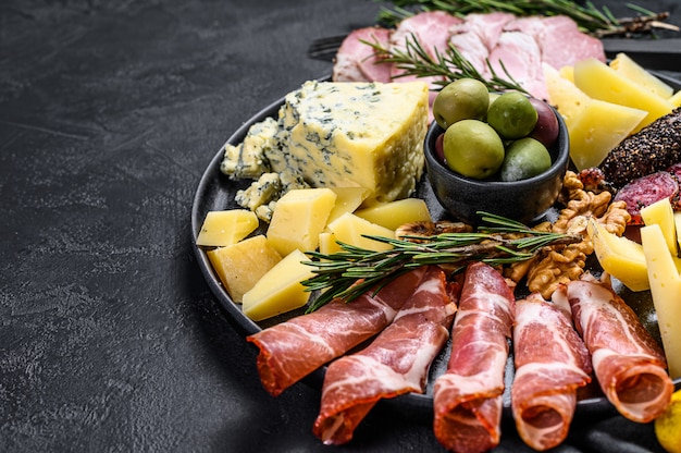 Typical italian antipasto with prosciutto, ham, cheese and olives.