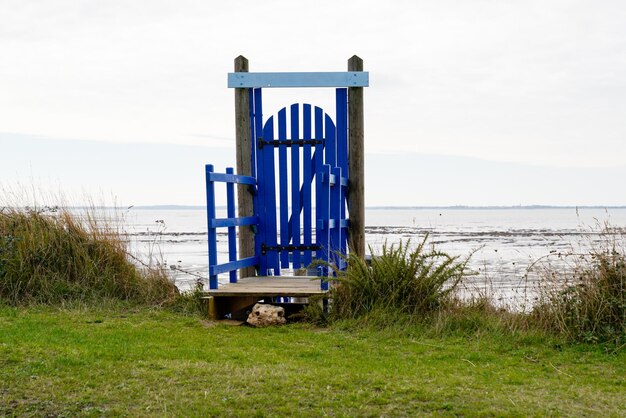 Typical old blue wooden door to access fishing huts on stilts in the atlantic ocean in fouras france