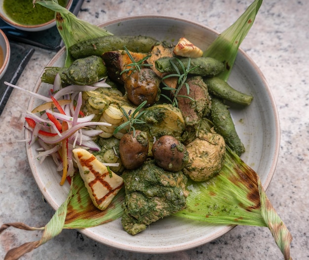 Photo typical peruvian dish, pachamanca, with alpaca, andean potato and different vegetables.