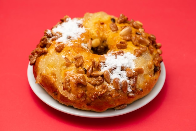 Typical portuguese fruit cake Bolo rainha on white dish