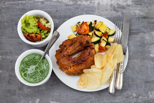 Typical portuguese smoked sausage alheira with chips and greens