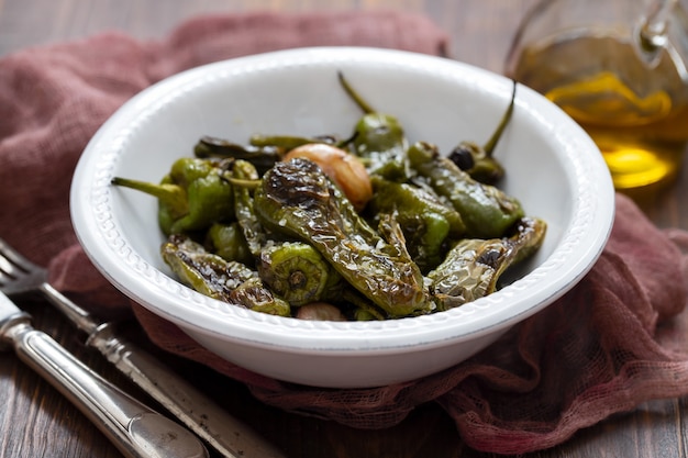 Typical spanish food grilled green pepper with salt on dish