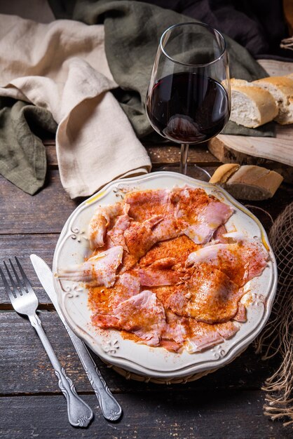 Typical Spanish tapa Galician cut pork with potatoes paprika and olive oil Appetizer lunch or dinner